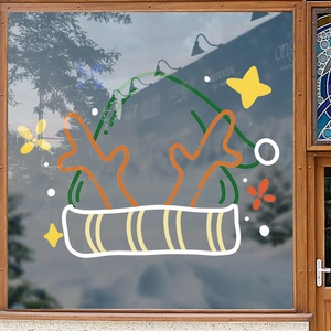 Christmas reindeer antlers and green hat static window decals on a wooden frame glass door