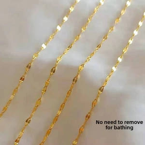 Detail of four golden titanium steel lip-link chains with polished finish texture