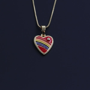 Detailed close-up of a gold heart pendant with red enamel, rainbow stripes, and a single diamond