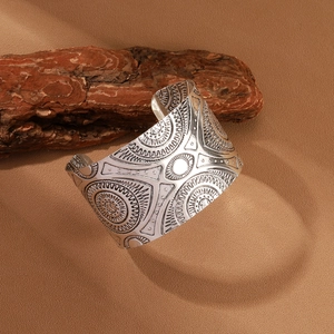 Vintage bohemian wide open bangle with intricate embossed floral patterns in silver finish