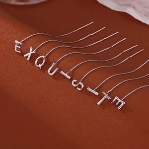 Elegant S925 silver threader earrings with EXQUISITE letter drop on leather background