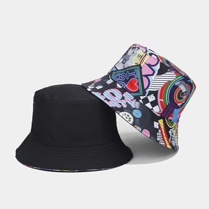 Reversible bucket hat with minimalist black and vibrant graffiti tape patterns