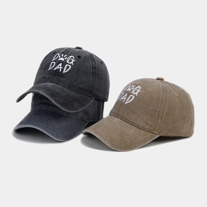 Detailed embroidery of DOG DAD text and paw print on washed cotton baseball caps