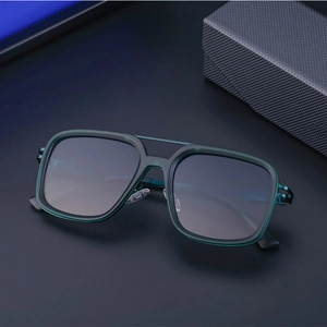 Close-up of retro square green sunglasses with double bridge and gradient lenses