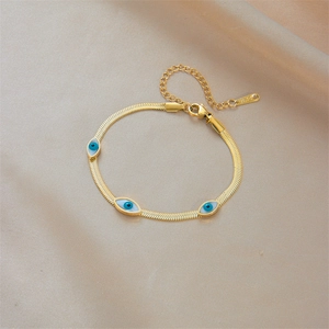 Gold stainless steel evil eye charm bracelet on premium champagne silk fabric