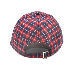 Detail of red and navy plaid cotton baseball cap featuring adjustable metal buckle