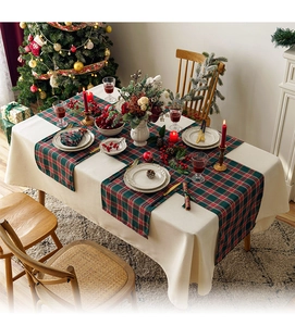 Christmas table runner with red and green plaid in a festive dining room setup