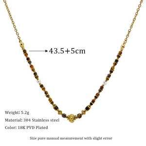 Detail of 18K PVD plated stainless steel necklace with faceted tiger eye and white beads