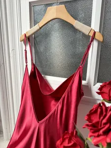 Detailed view of the smooth red silk satin nightgown fabric with elegant V-neck design