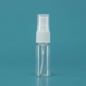 Close-up of portable clear plastic spray bottle with white mist pump and transparent cap