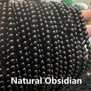 Close-up of polished natural obsidian round beads for DIY jewelry making and beading
