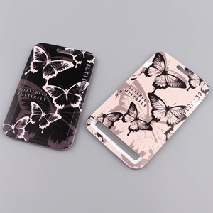 Detail of black and pink hard plastic ID holders with butterfly patterns and lanyards
