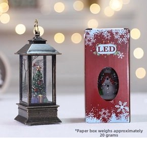 Detail of vintage Christmas lantern with LED tree and matching red gift box