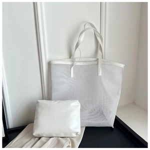White mesh beach tote bag and matching inner pouch shown on a modern minimalist display