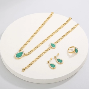 Golden titanium steel jewelry set with teardrop green stones and crystal halo