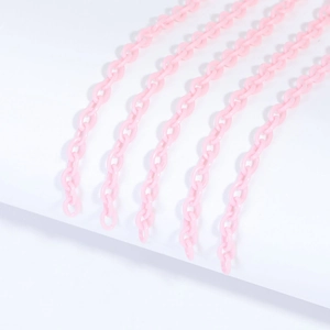 Detail of pink acrylic chain links for DIY jewelry making on white background