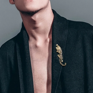 Elegant gold leopard brooch with black crystal inlay on model garment