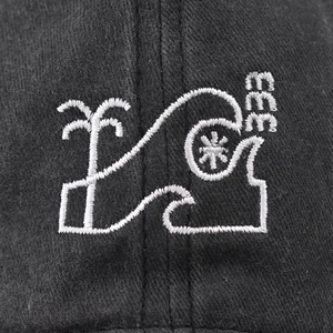 Macro shot of embroidered white coconut tree and number 333 on black washed cotton cap