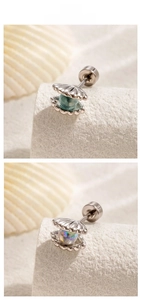 Detailed close-up of shell-shaped titanium steel ear studs with colorful bead inlays