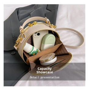 Internal capacity of beige round crossbody bag showing daily essentials and lining