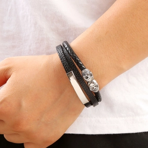 Bracelet homme en cuir tressé avec crânes en acier inoxydable et barre en métal