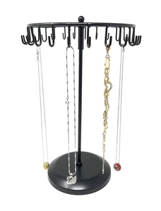 Close-up of rotating jewelry display rack featuring multiple hooks and a stable round base