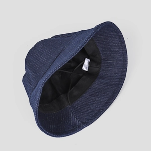 Detail of dark blue denim bucket hat interior with sweatband and adjustable wind rope
