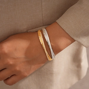 18k gold plated bangle set with zircons featuring a cross buckle design on female wrist