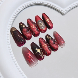 Deep burgundy cat eye press on nails with gold stars and 3D embossed details