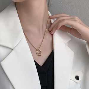 Minimalist gold titanium steel necklace with irregular geometric heart pendant on a model