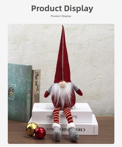 Detail of Christmas gnome plush with striped long legs and a tall red pointed hat