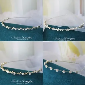 Detail of thin metal headbands featuring leaf designs, pearls, and rhinestones