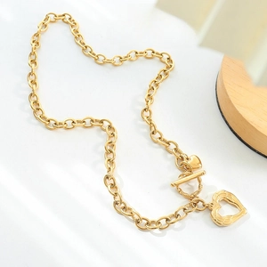 Chunky gold chain necklace with heart pendants and toggle clasp on a stylish background