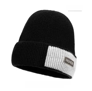Detailed close-up of winter knitted beanie with fleece lining and fashion leather patch