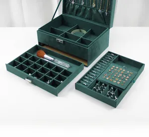 Three-layer dark green velvet jewelry box detail showing necklace hooks and ring slots