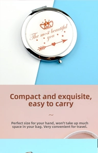 Detail view of a portable mini folding mirror with crown motif and silver metal frame