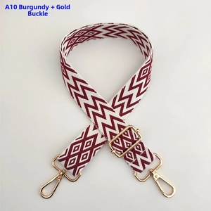 Close-up of adjustable burgundy wavy strap with elegant golden metal hooks