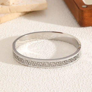 Silver titanium steel bracelet featuring Greek key pattern and double row rhinestones