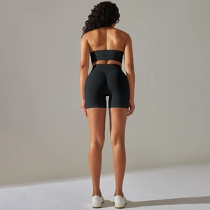 Close-up of seamless black ribbed workout set featuring racerback top and high waist shorts