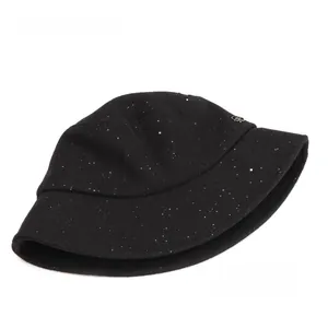 Detailed view of black wool bucket hat with sparkling silver sequins and metal emblem