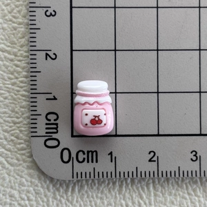 Miniature pink resin jar charm with cherry pattern and ruler showing 1.3cm height