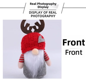 Close-up of Christmas gnome plush with red knitted hat, brown antlers and long white beard