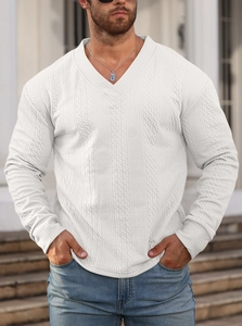Close-up of white V-neck knit sweater showing intricate cable knit texture on male model