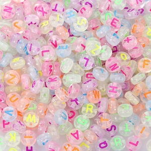 Close-up of colorful round acrylic alphabet beads for DIY jewelry and kids crafts
