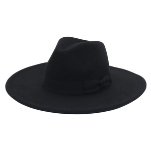 Detail of elegant black wool fedora with a matching ribbon bow on wide brim