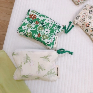 Detail of floral cotton pouches with zipper closures and simple wish fabric labels