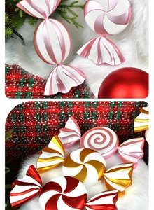Close-up of sparkling Christmas candy pendants with red, gold and pink spiral stripes