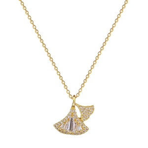 Elegant gold ginkgo leaf necklace with sparkling crystals on a plain white background