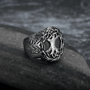 Vintage Tree of Life stainless steel ring for men displayed on a grey rock surface
