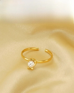 Detailed close-up of 18k gold plated stainless steel ring with elegant white pearl inlay